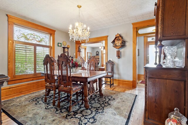 368 E 300 N, Logan, UT 84321 - dining space featuring baseboards, an inviting chandelier, and light wood-style flooring
