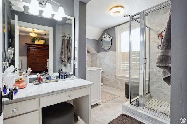 368 E 300 N, Logan, UT 84321 - bathroom with a shower stall, vanity, marble finish floor, visible vents, and lofted ceiling