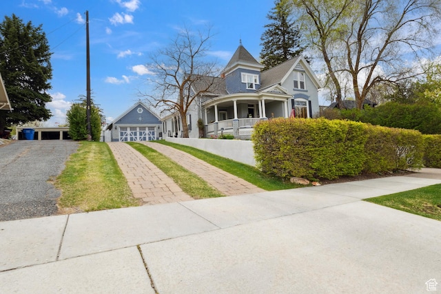 368 E 300 N, Logan, UT 84321 - victorian house with covered porch, a garage, and aphalt driveway