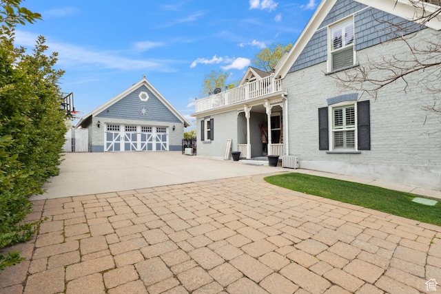 368 E 300 N, Logan, UT 84321 - view of front of property with driveway, a balcony, brick siding, and an outbuilding