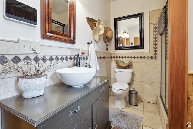 368 E 300 N, Logan, UT 84321 - full bathroom with tile patterned flooring, a shower stall, tile walls, toilet, and vanity