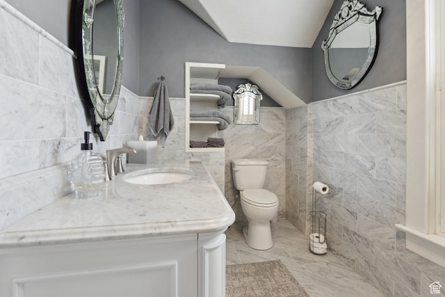 368 E 300 N, Logan, UT 84321 - bathroom featuring toilet, a wainscoted wall, tile walls, and a sink