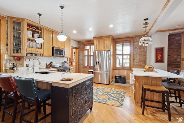 368 E 300 N, Logan, UT 84321 - kitchen with a sink, a peninsula, stainless steel appliances, and light countertops