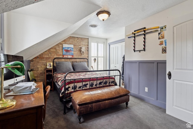 368 E 300 N, Logan, UT 84321 - bedroom featuring a textured ceiling, carpet flooring, visible vents, a decorative wall, and wainscoting