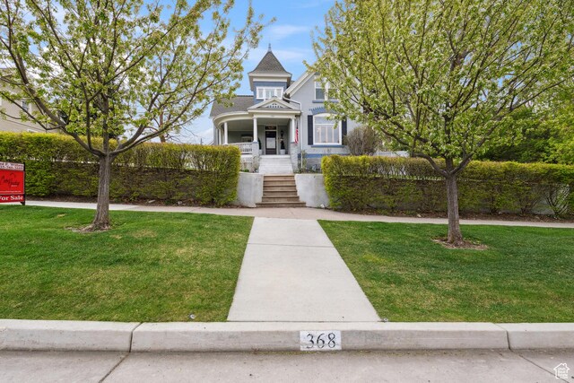 368 E 300 N, Logan, UT 84321 - victorian-style house featuring a porch, a front lawn, and stairs