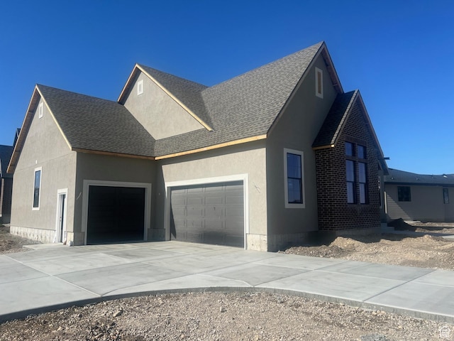551 W Summerhill Ln, Centerville, UT 84014 - view of property exterior featuring an attached garage, driveway, roof with shingles, and stucco siding