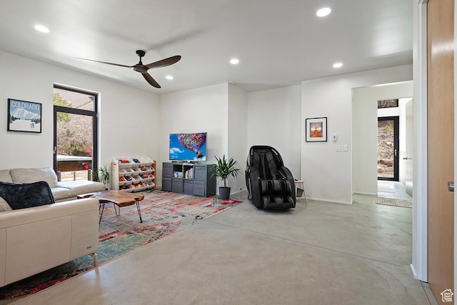 living area featuring recessed lighting, ceiling fan, and concrete flooring