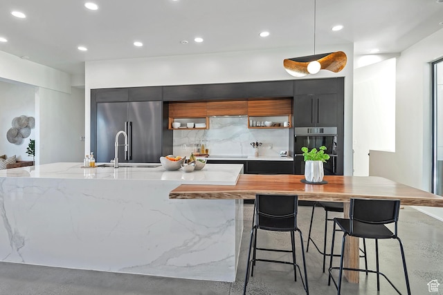 kitchen with decorative backsplash, dobule oven black, modern cabinets, high quality fridge, and dark cabinets