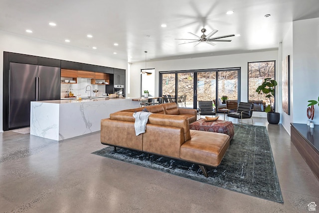 living room with concrete floors, recessed lighting, and a ceiling fan