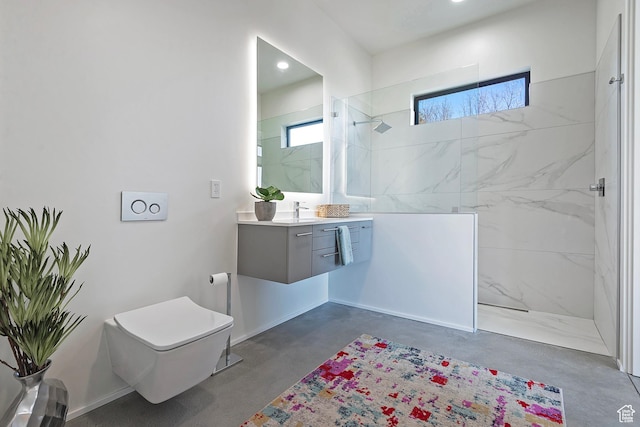 bathroom with toilet, vanity, a marble finish shower, concrete floors, and baseboards