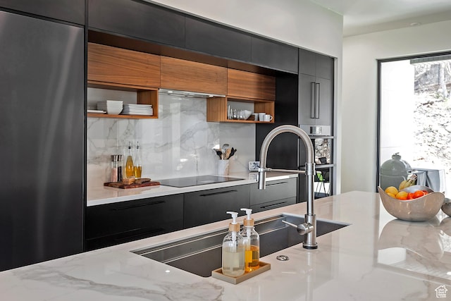 kitchen featuring decorative backsplash, modern cabinets, black electric stovetop, open shelves, and dark cabinetry