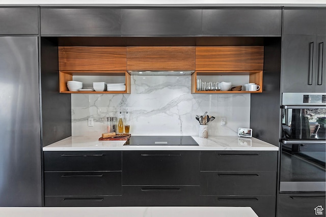 kitchen featuring black electric cooktop, modern cabinets, open shelves, and stainless steel fridge