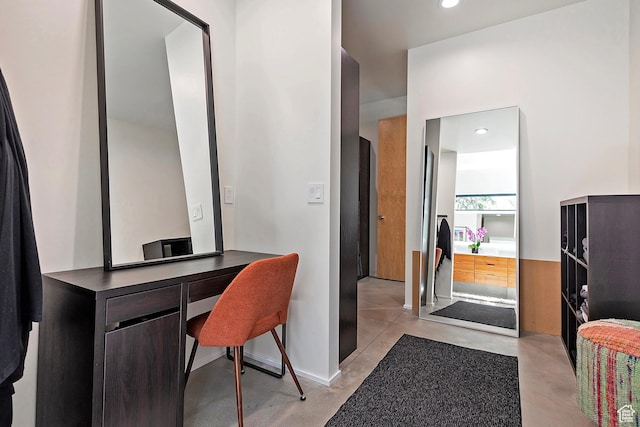 office area featuring baseboards, recessed lighting, and finished concrete floors