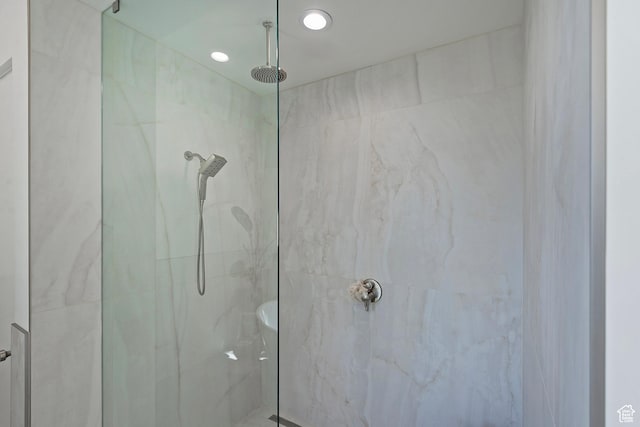 full bathroom featuring a marble finish shower