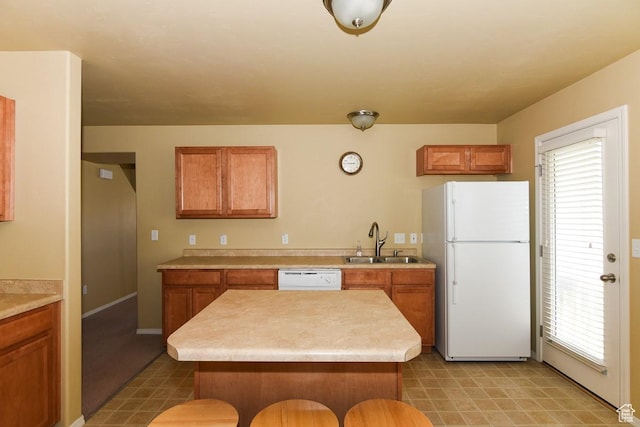 202 E Aparicio Dr, Tooele, UT 84074 - kitchen featuring light countertops, a sink, brown cabinetry, and white appliances