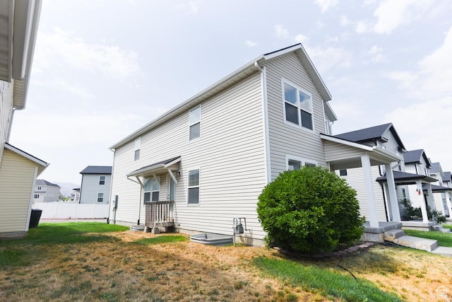 202 E Aparicio Dr, Tooele, UT 84074 - rear view of house featuring a yard