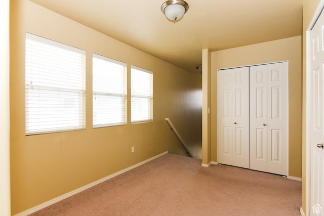 202 E Aparicio Dr, Tooele, UT 84074 - unfurnished bedroom with baseboards, a closet, and light colored carpet