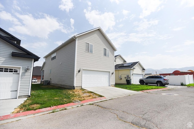 202 E Aparicio Dr, Tooele, UT 84074 - view of side of home with central AC unit and a garage