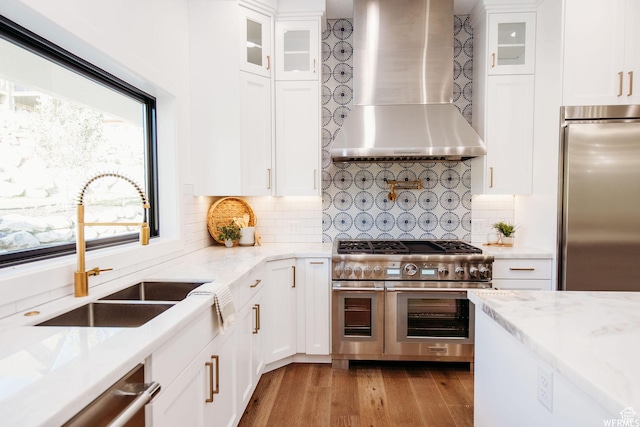 1154 Fawn, Pleasant View, UT 84414 - kitchen featuring a sink, high quality appliances, light wood finished floors, wall chimney range hood, and white cabinets