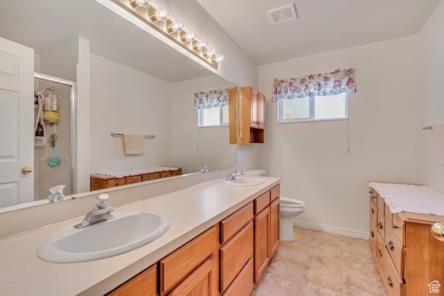 full bath with double vanity, a sink, a stall shower, and visible vents
