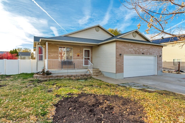 ranch-style home featuring brick siding, driveway, fence, and an attached garage