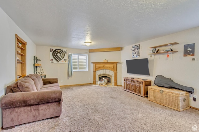 carpeted living area featuring baseboards, a tiled fireplace, and a textured ceiling