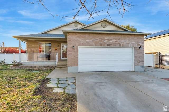 single story home with an attached garage, a porch, brick siding, and concrete driveway