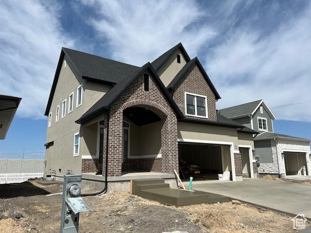 2131 N 725 W, Centerville, UT 84014 - view of front of house with brick siding, stucco siding, driveway, and an attached garage