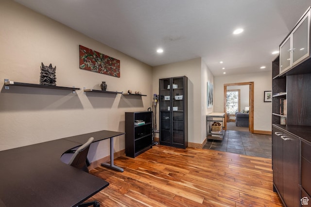 office space featuring recessed lighting, baseboards, and hardwood / wood-style flooring