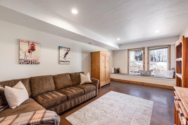 living area featuring baseboards, recessed lighting, finished concrete floors, and visible vents