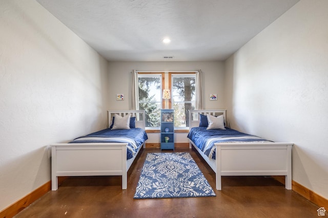 bedroom featuring baseboards and visible vents