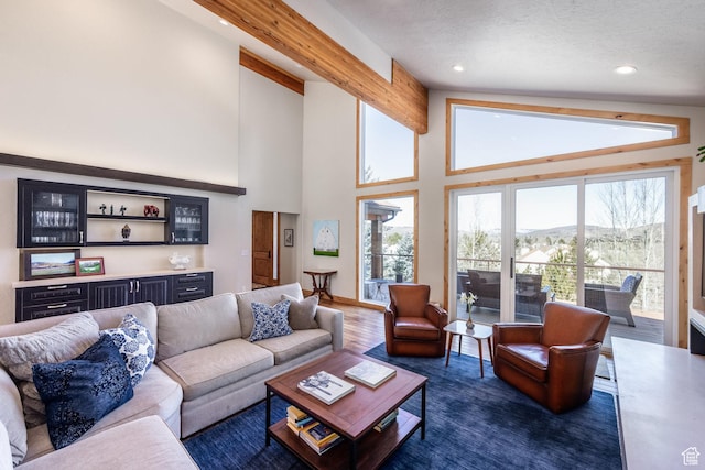 living area featuring recessed lighting, high vaulted ceiling, a dry bar, and dark wood-type flooring