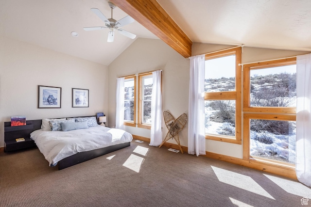 bedroom with carpet floors, multiple windows, and lofted ceiling with beams