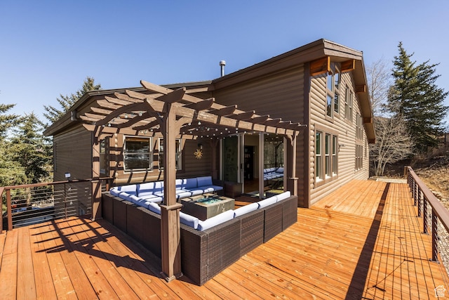 deck with an outdoor living space with a fire pit and a pergola