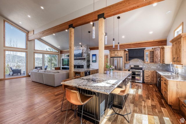 kitchen featuring a sink, high vaulted ceiling, stainless steel appliances, and a healthy amount of sunlight