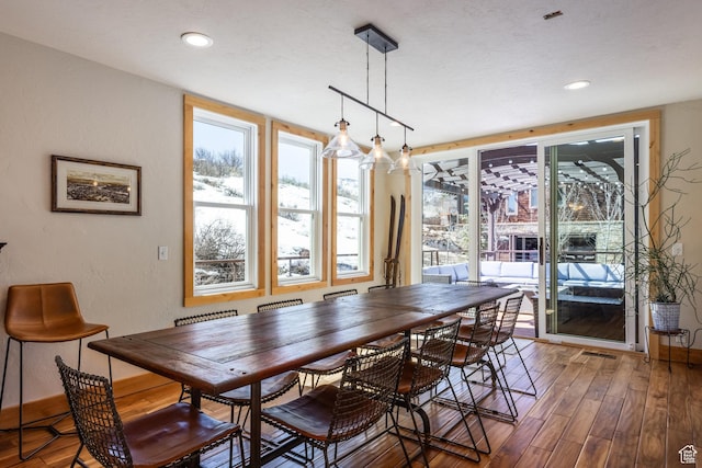 dining space featuring plenty of natural light, recessed lighting, wood finished floors, and visible vents