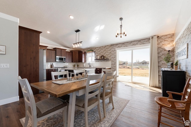 185 W 200 N, Centerfield, UT 84622 - dining room with vaulted ceiling, a chandelier, wood finished floors, brick wall, and recessed lighting