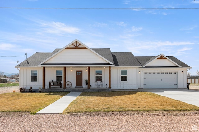 modern inspired farmhouse featuring a front yard, board and batten siding, a porch, and driveway
