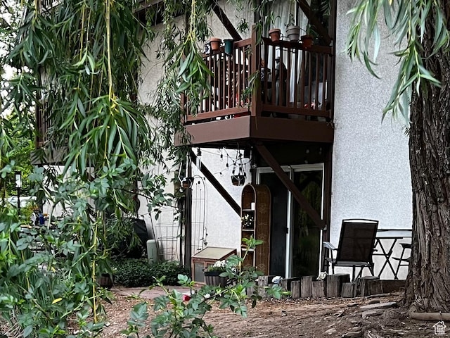 5560 S Willow Ln E Unit A, Murray, UT 84107 - rear view of property featuring stucco siding and a wooden deck