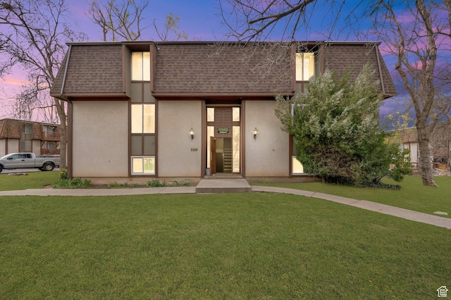 5560 S Willow Ln E Unit A, Murray, UT 84107 - view of front of home featuring roof with shingles, mansard roof, a front lawn, and stucco siding
