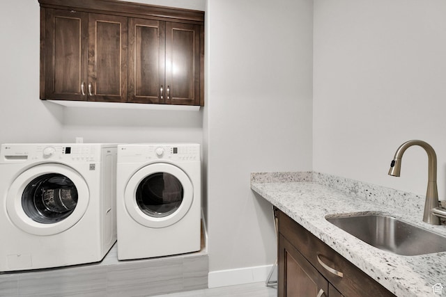 8165 S Willow Creek Cv E, Cottonwood Heights, UT 84093 - laundry room with a sink, cabinet space, baseboards, and washer and dryer