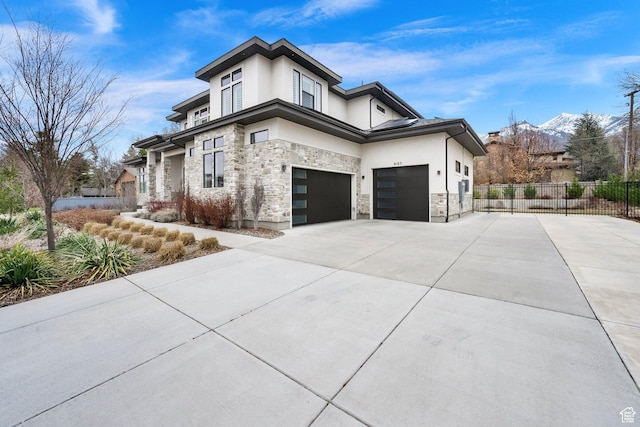 8165 S Willow Creek Cv E, Cottonwood Heights, UT 84093 - view of side of home with stone siding, concrete driveway, stucco siding, fence, and an attached garage