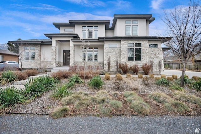 prairie-style home with stone siding and stucco siding