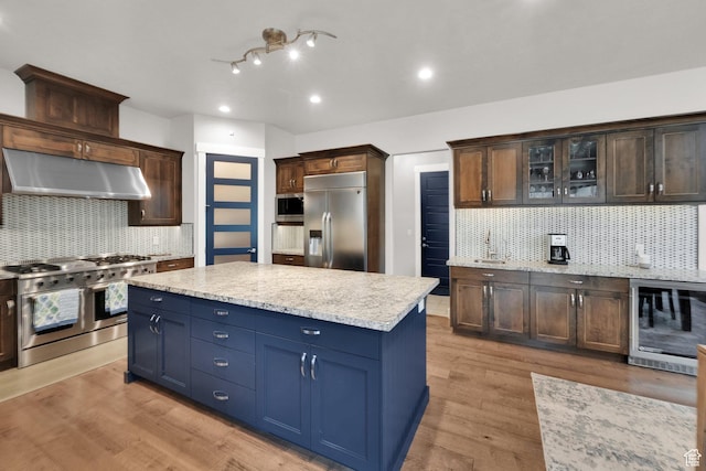 8165 S Willow Creek Cv E, Cottonwood Heights, UT 84093 - kitchen featuring wine cooler, appliances with stainless steel finishes, glass insert cabinets, under cabinet range hood, and light wood-style floors