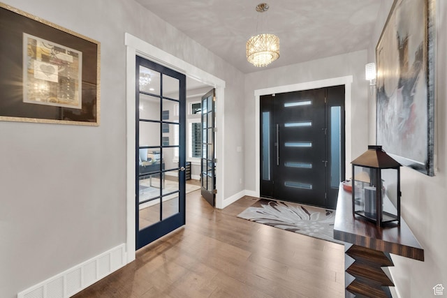 8165 S Willow Creek Cv E, Cottonwood Heights, UT 84093 - entrance foyer with french doors, baseboards, visible vents, a notable chandelier, and wood finished floors