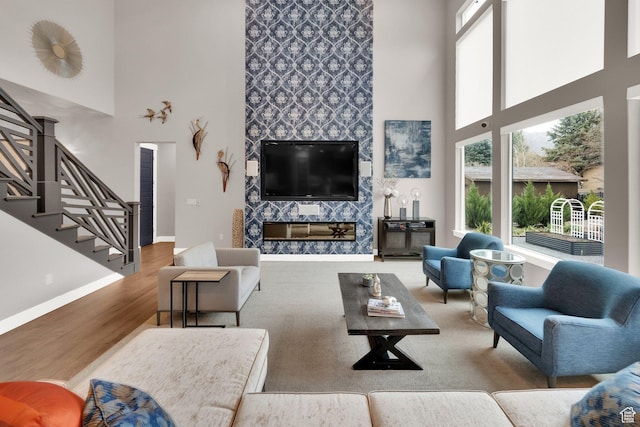 8165 S Willow Creek Cv E, Cottonwood Heights, UT 84093 - living area with a towering ceiling, baseboards, stairway, and wood finished floors