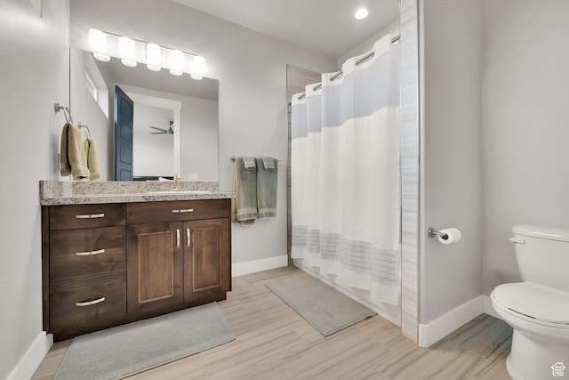 8165 S Willow Creek Cv E, Cottonwood Heights, UT 84093 - bathroom with baseboards, toilet, vanity, and wood finished floors