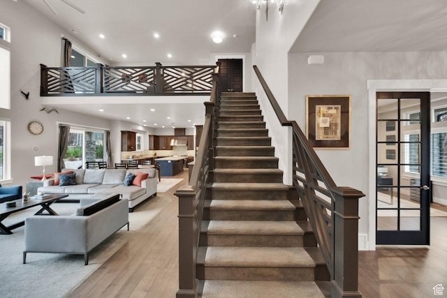 8165 S Willow Creek Cv E, Cottonwood Heights, UT 84093 - stairs featuring a high ceiling, wood finished floors, and recessed lighting