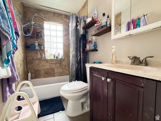 full bath featuring tile patterned floors, toilet, shower / tub combo with curtain, vanity, and a textured ceiling