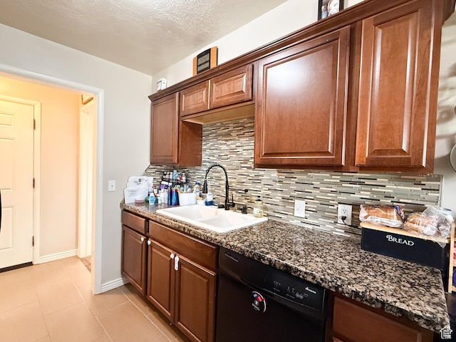 kitchen featuring backsplash, a sink, a textured ceiling, black dishwasher, and baseboards